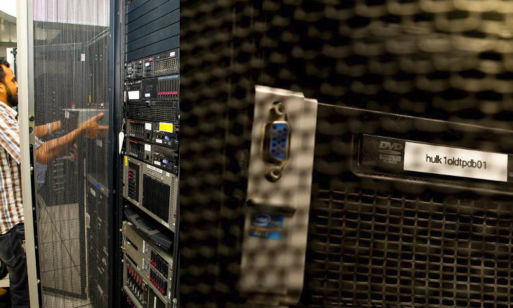 Left: A technician replaces part of a rack. On the right, the hulk. 