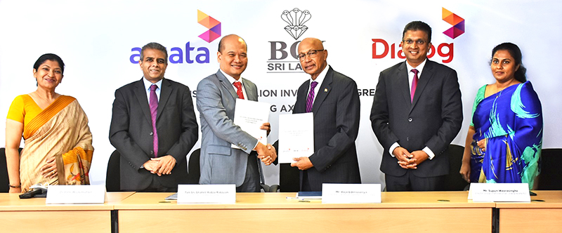 Dialog Axiata team posing for a picture with the BOI team after signing agreements to invest USD 152.4 million.