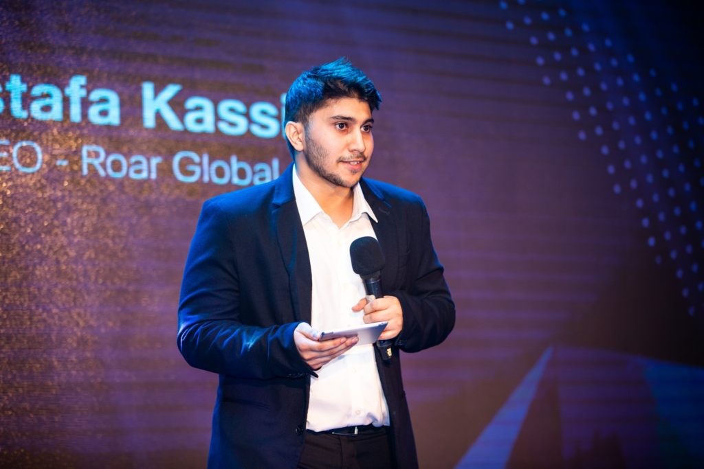 Image of Roar Global CEO Mustafa Kassim on stage