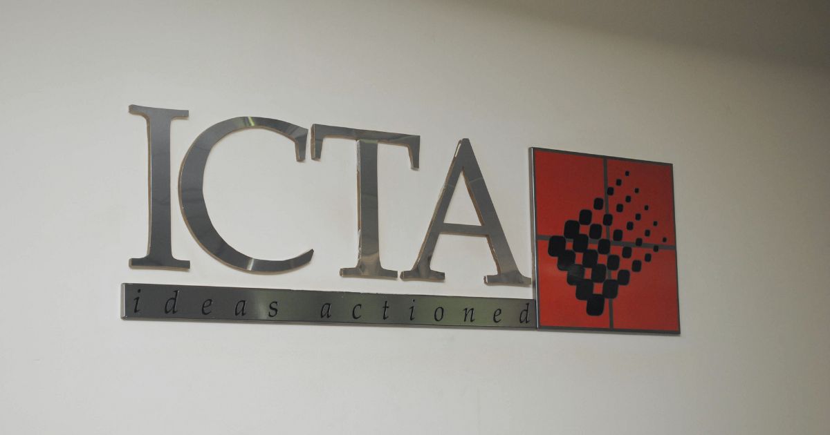 Image of the ICTA logo on a white wall with the tagline "ideas actioned"